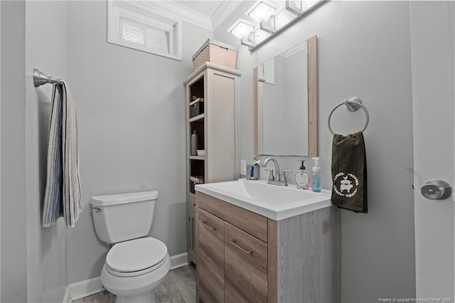 521 Cedar Creek Rd, Fayetteville, NC 28312 - bathroom with ornamental molding, toilet, vanity, baseboards, and wood finished floors