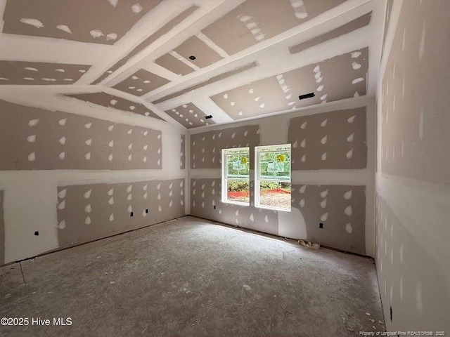 unfurnished room featuring lofted ceiling
