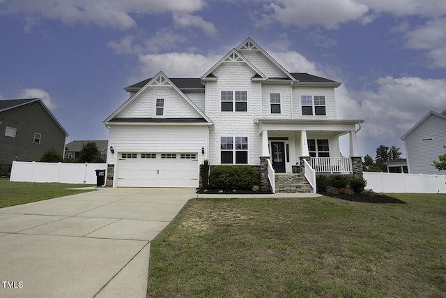 craftsman inspired home featuring covered porch, an attached garage, driveway, and stone siding