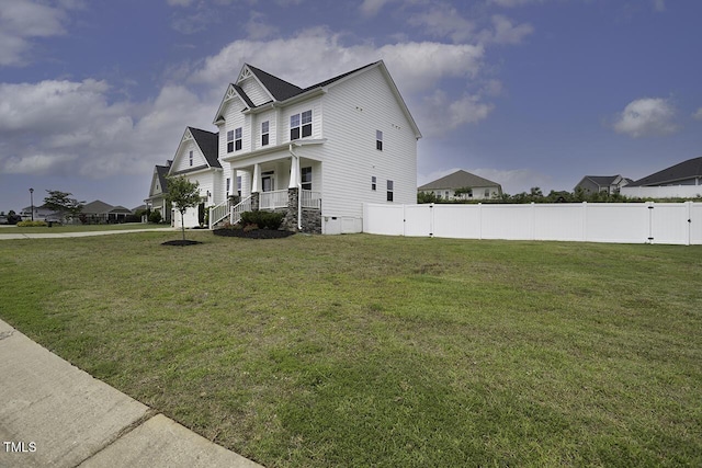 view of home's exterior featuring covered porch and a gate