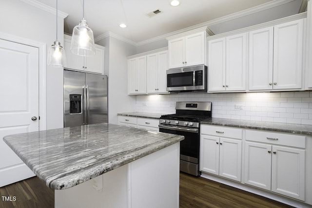 kitchen with appliances with stainless steel finishes, dark wood-type flooring, crown molding, recessed lighting, and white cabinetry