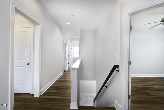hall featuring an upstairs landing, dark wood finished floors, recessed lighting, and baseboards