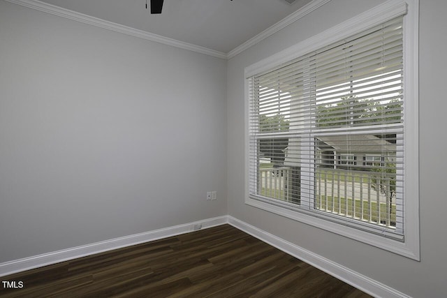 spare room featuring dark wood-style floors, baseboards, crown molding, and a ceiling fan