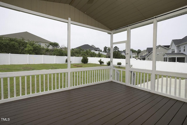 unfurnished sunroom with lofted ceiling and a residential view