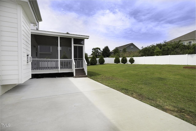 view of yard featuring a sunroom and a patio