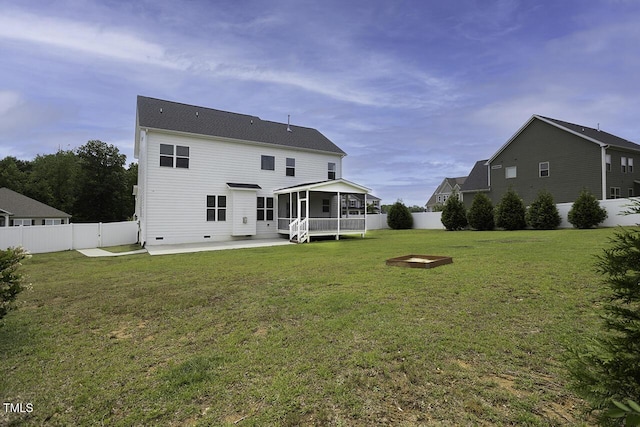 rear view of property with a sunroom and a patio area
