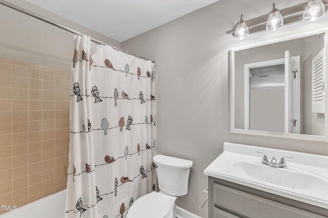 bathroom featuring toilet, vanity, and shower / bath combination with curtain