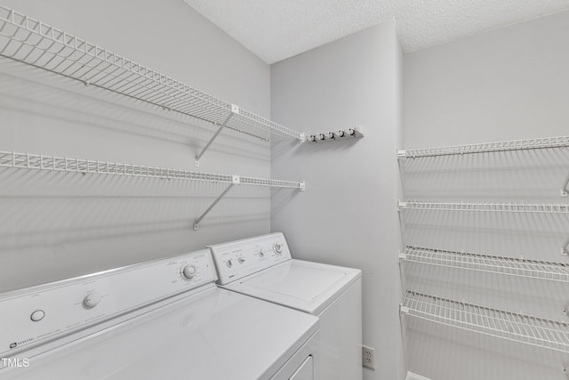 clothes washing area with washing machine and dryer