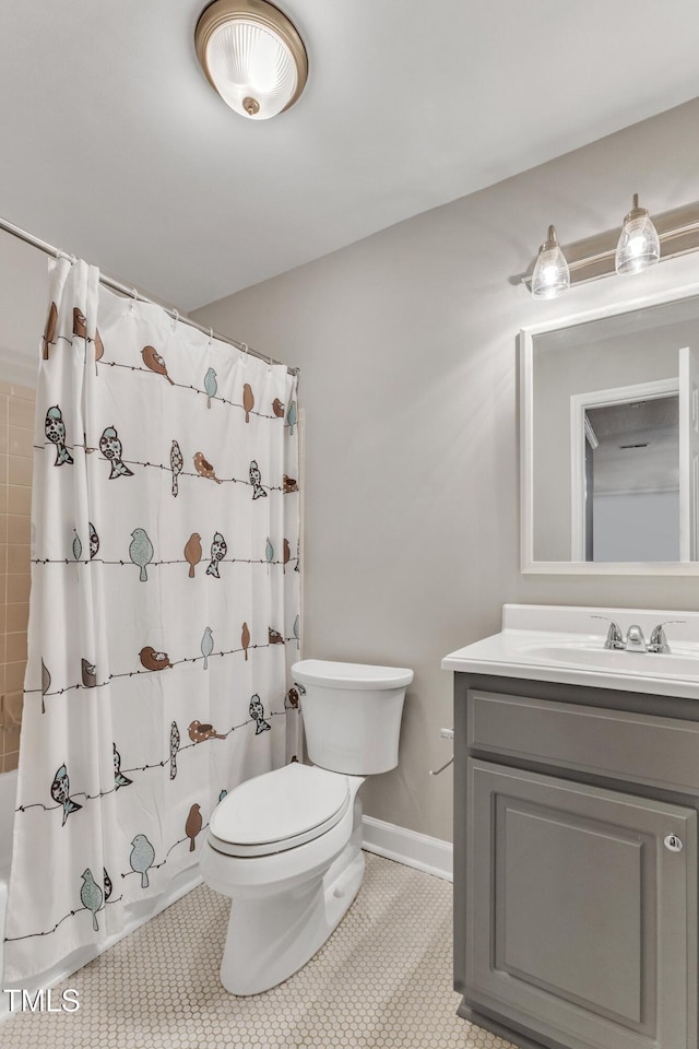 full bathroom featuring toilet, vanity, shower / tub combo with curtain, baseboards, and tile patterned floors