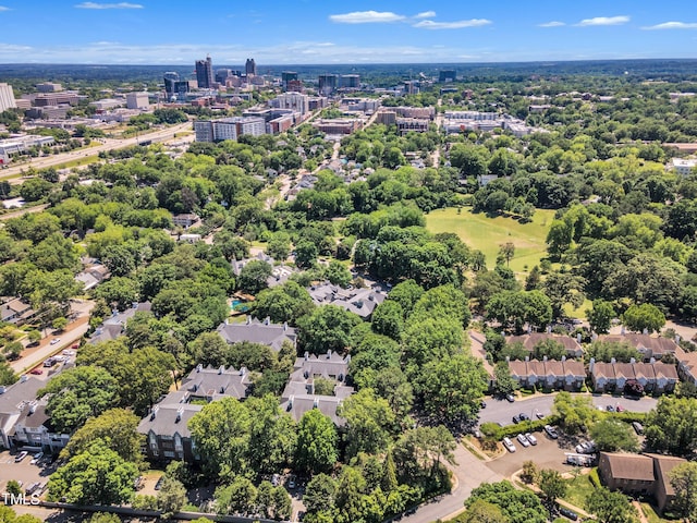 view of urban area with a tree filled landscape