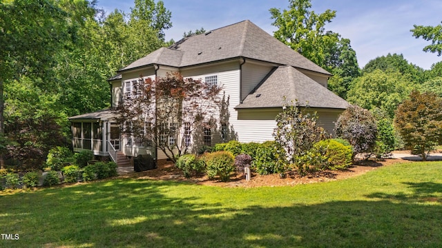 1329 Wynncrest Ct, Raleigh, NC 27603 - view of property exterior featuring a sunroom, a yard, and a shingled roof