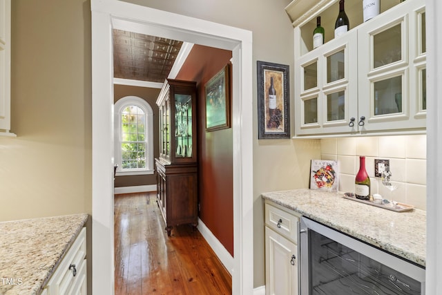1329 Wynncrest Ct, Raleigh, NC 27603 - indoor dry bar with beverage cooler, wood-type flooring, baseboards, backsplash, and crown molding