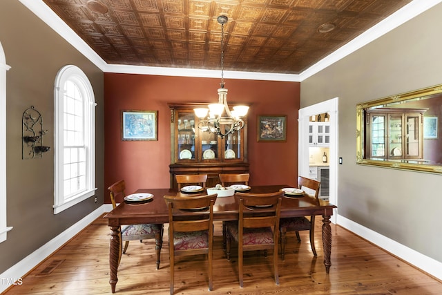 1329 Wynncrest Ct, Raleigh, NC 27603 - dining room with an ornate ceiling, ornamental molding, wood-type flooring, a chandelier, and baseboards