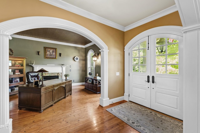 1329 Wynncrest Ct, Raleigh, NC 27603 - entryway with arched walkways, ornate columns, ornamental molding, and a fireplace