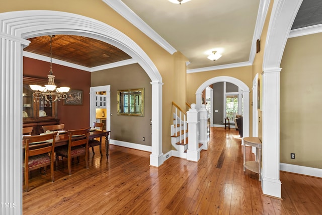 1329 Wynncrest Ct, Raleigh, NC 27603 - entrance foyer featuring arched walkways, light wood-style flooring, baseboards, ornate columns, and ornamental molding