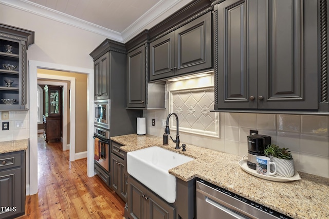 1329 Wynncrest Ct, Raleigh, NC 27603 - kitchen featuring a sink, stainless steel appliances, decorative backsplash, crown molding, and light stone countertops