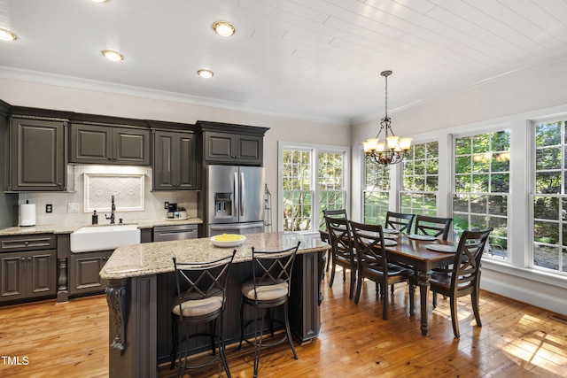 1329 Wynncrest Ct, Raleigh, NC 27603 - kitchen featuring stainless steel appliances, a sink, crown molding, plenty of natural light, and a chandelier