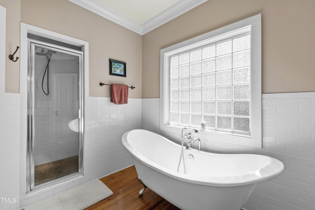 1329 Wynncrest Ct, Raleigh, NC 27603 - bathroom with tile walls, a stall shower, wood finished floors, a wainscoted wall, and a freestanding bath