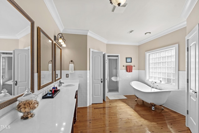 1329 Wynncrest Ct, Raleigh, NC 27603 - bathroom with tile walls, a wainscoted wall, crown molding, a shower stall, and a freestanding bath