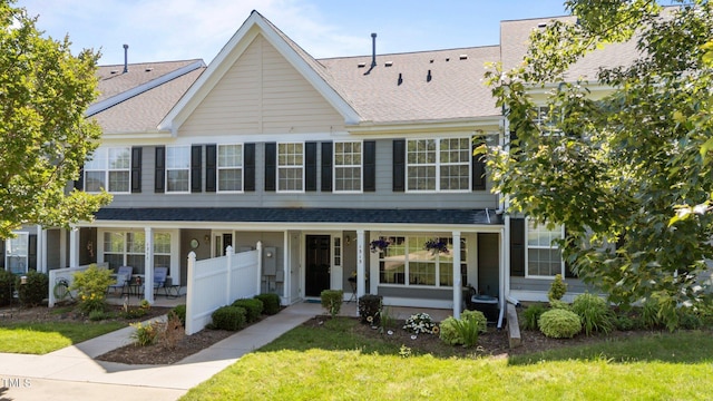 1313 Legacy Greene Ave, Wake Forest, NC 27587 - multi unit property featuring a porch, roof with shingles, a front lawn, and central AC unit