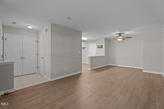 1313 Legacy Greene Ave, Wake Forest, NC 27587 - unfurnished living room featuring ceiling fan, light wood-type flooring, and baseboards