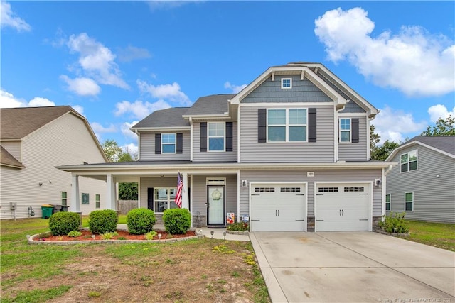 3821 Shire St, Hope Mills, NC 28348 - craftsman house featuring an attached garage, concrete driveway, stone siding, covered porch, and a front lawn