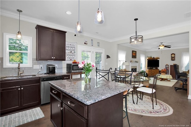 3821 Shire St, Hope Mills, NC 28348 - kitchen with stainless steel appliances, a sink, dark wood-style floors, dark brown cabinetry, and ornamental molding