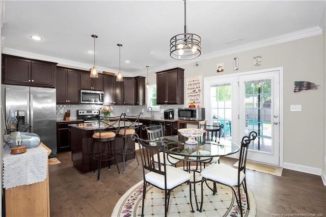 3821 Shire St, Hope Mills, NC 28348 - dining area with crown molding, dark wood finished floors, recessed lighting, and baseboards