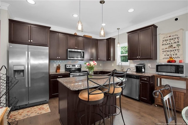 3821 Shire St, Hope Mills, NC 28348 - kitchen featuring stainless steel appliances, dark brown cabinets, crown molding, light stone countertops, and dark wood-style flooring