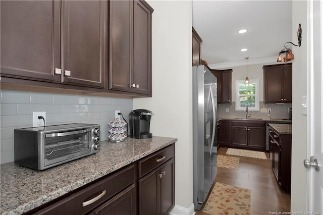 3821 Shire St, Hope Mills, NC 28348 - kitchen featuring stainless steel refrigerator with ice dispenser, decorative backsplash, a sink, ornamental molding, and light stone countertops