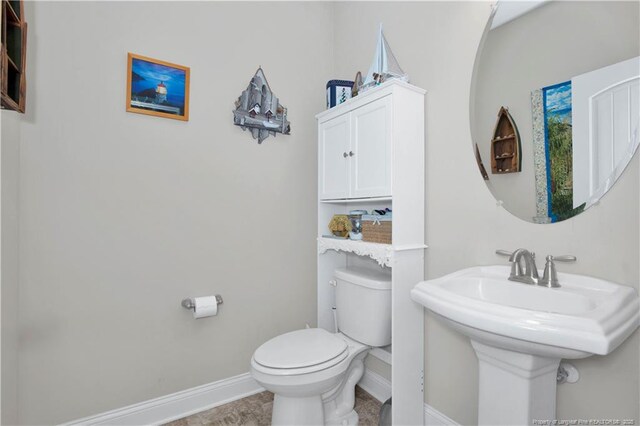 3821 Shire St, Hope Mills, NC 28348 - bathroom with baseboards, toilet, and a sink