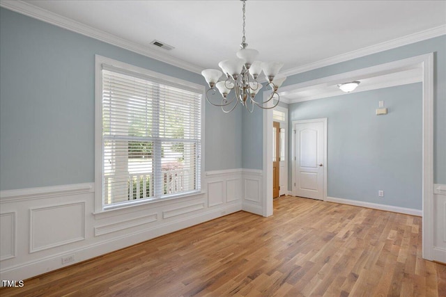 120 Tanager Farms Dr, Youngsville, NC 27596 - empty room with a chandelier, light wood finished floors, wainscoting, and crown molding
