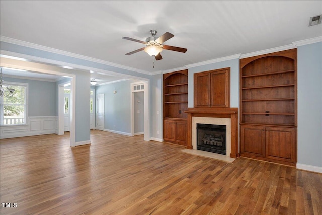 120 Tanager Farms Dr, Youngsville, NC 27596 - unfurnished living room with a ceiling fan, a fireplace with flush hearth, light wood-type flooring, built in features, and ornamental molding