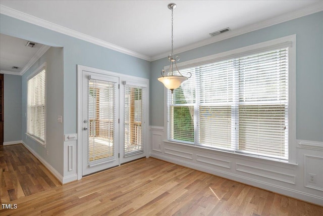 120 Tanager Farms Dr, Youngsville, NC 27596 - unfurnished dining area with light wood-style floors, ornamental molding, and wainscoting