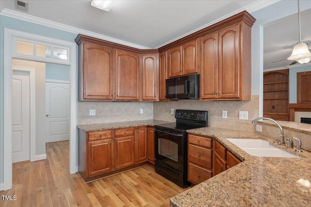 120 Tanager Farms Dr, Youngsville, NC 27596 - kitchen featuring black appliances, a sink, light wood-style flooring, backsplash, and crown molding