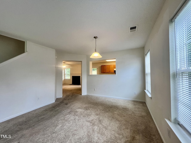 5911 Endsley Ct, Raleigh, NC 27610 - unfurnished living room featuring carpet floors, baseboards, and a fireplace