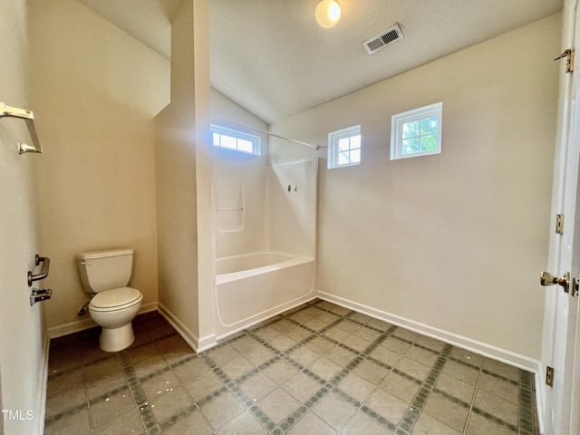 5911 Endsley Ct, Raleigh, NC 27610 - bathroom featuring toilet, vaulted ceiling, tub / shower combination, and baseboards