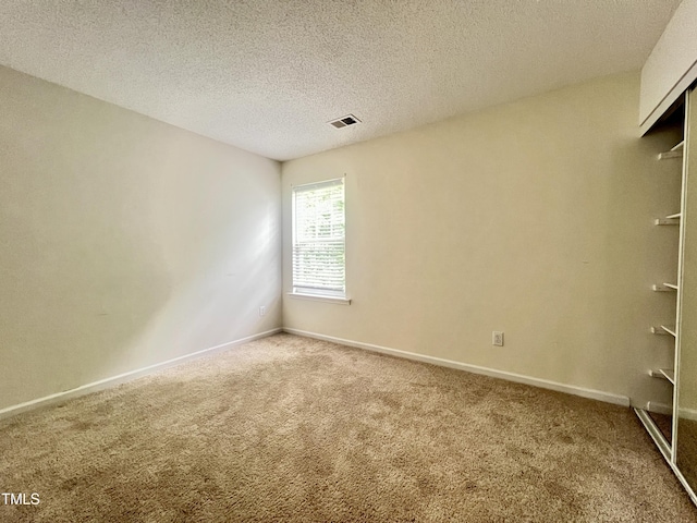 5911 Endsley Ct, Raleigh, NC 27610 - spare room featuring carpet floors, a textured ceiling, and baseboards