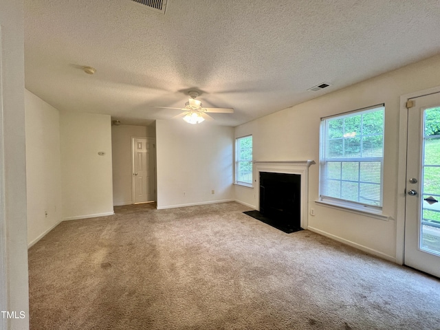 5911 Endsley Ct, Raleigh, NC 27610 - unfurnished living room with carpet, ceiling fan, baseboards, a textured ceiling, and a fireplace with flush hearth