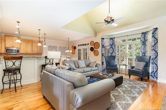  - living area with a ceiling fan and light wood-style floors