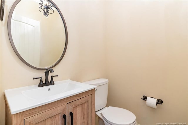  - bathroom featuring toilet and vanity