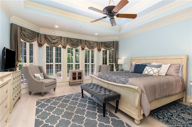  - bedroom with ornamental molding, a raised ceiling, light wood finished floors, and ceiling fan