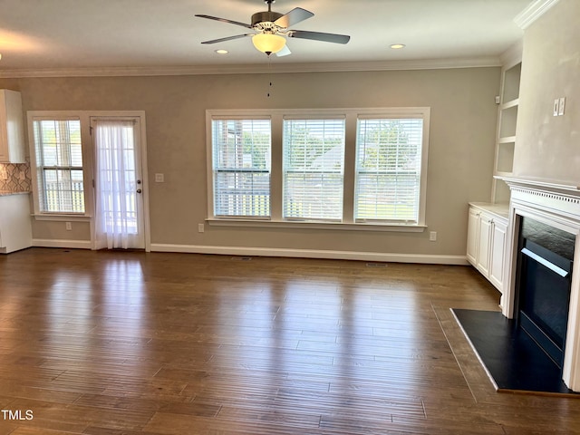 123 Gunderson Ln, Garner, NC 27529 - unfurnished living room featuring a high end fireplace, healthy amount of natural light, a ceiling fan, dark wood-style floors, and ornamental molding
