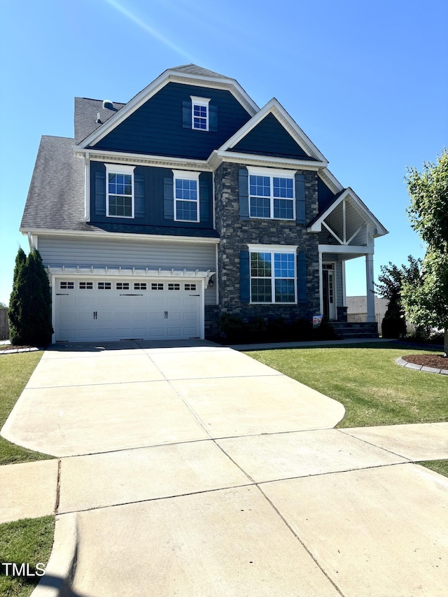 123 Gunderson Ln, Garner, NC 27529 - view of front facade with driveway, stone siding, a front yard, and a garage