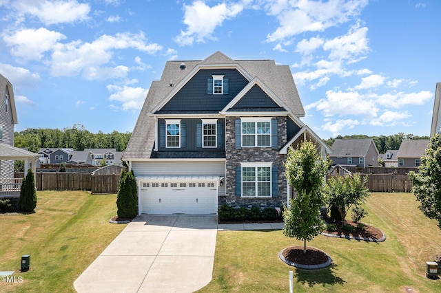 123 Gunderson Ln, Garner, NC 27529 - view of front of house featuring driveway, stone siding, and a garage