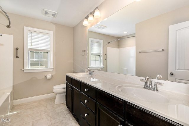 123 Gunderson Ln, Garner, NC 27529 - bathroom with double vanity, shower / bath combination, toilet, and baseboards