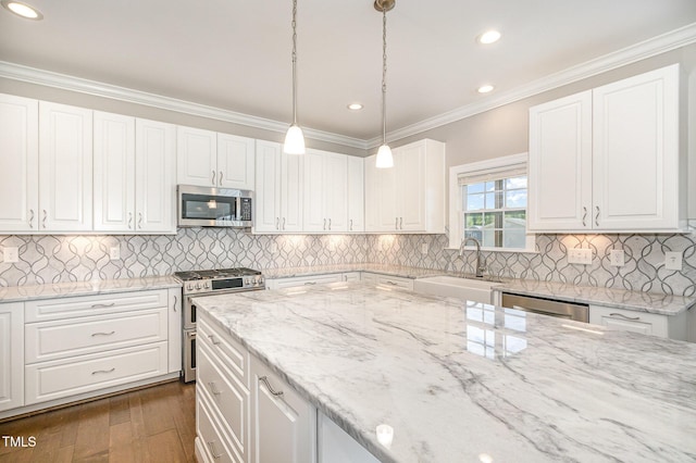 123 Gunderson Ln, Garner, NC 27529 - kitchen with appliances with stainless steel finishes, a sink, white cabinets, light stone counters, and crown molding