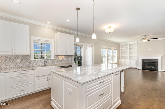 123 Gunderson Ln, Garner, NC 27529 - kitchen featuring a sink, a kitchen island, ceiling fan, dark wood-style floors, and a fireplace