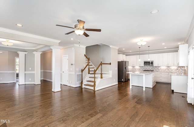 123 Gunderson Ln, Garner, NC 27529 - unfurnished living room with ceiling fan, dark wood-type flooring, recessed lighting, ornamental molding, and stairway
