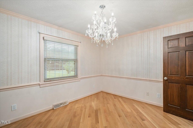 8133 Holly Forest Rd, Wake Forest, NC 27587 - unfurnished room featuring a chandelier, wood finished floors, ornamental molding, baseboards, and a textured ceiling